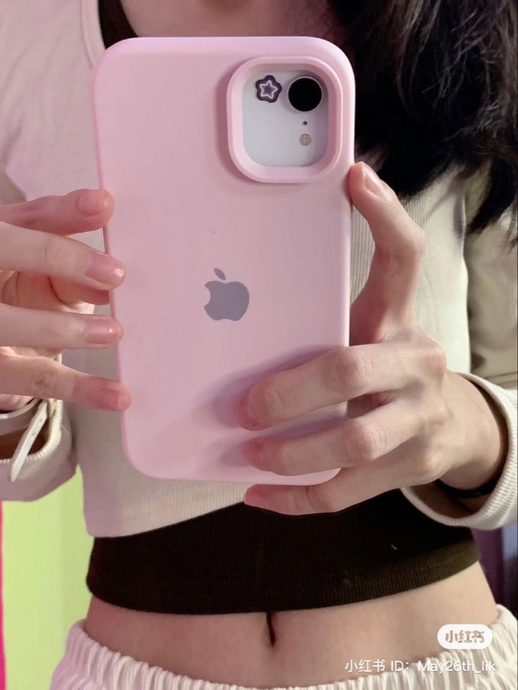 a woman holding an iphone case in her hands