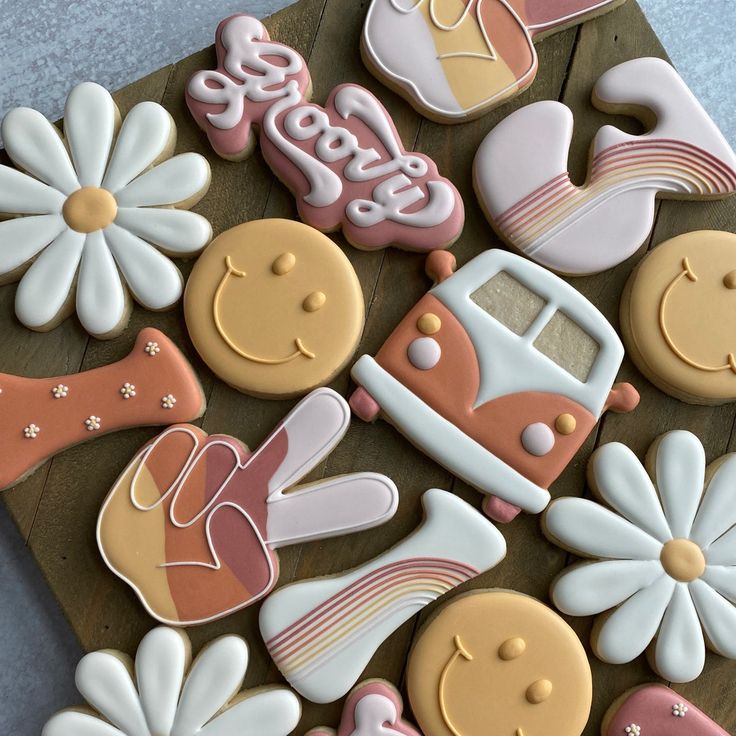 decorated cookies are arranged on a wooden board