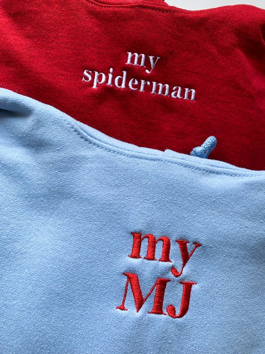 two red and blue shirts with the words my spiderman written on them are laying next to each other