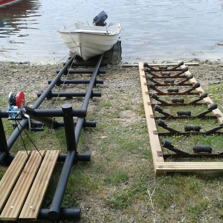 two boats are parked on the shore next to some wooden planks that have been placed together