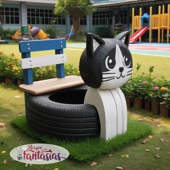 a black and white cat sitting on top of a wooden bench next to a tire