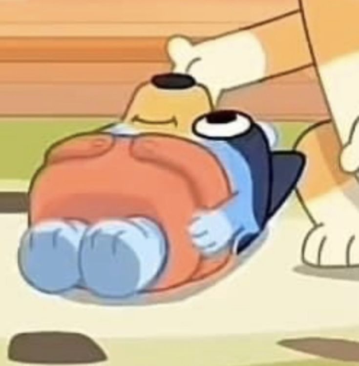 a cartoon dog laying on top of a bed