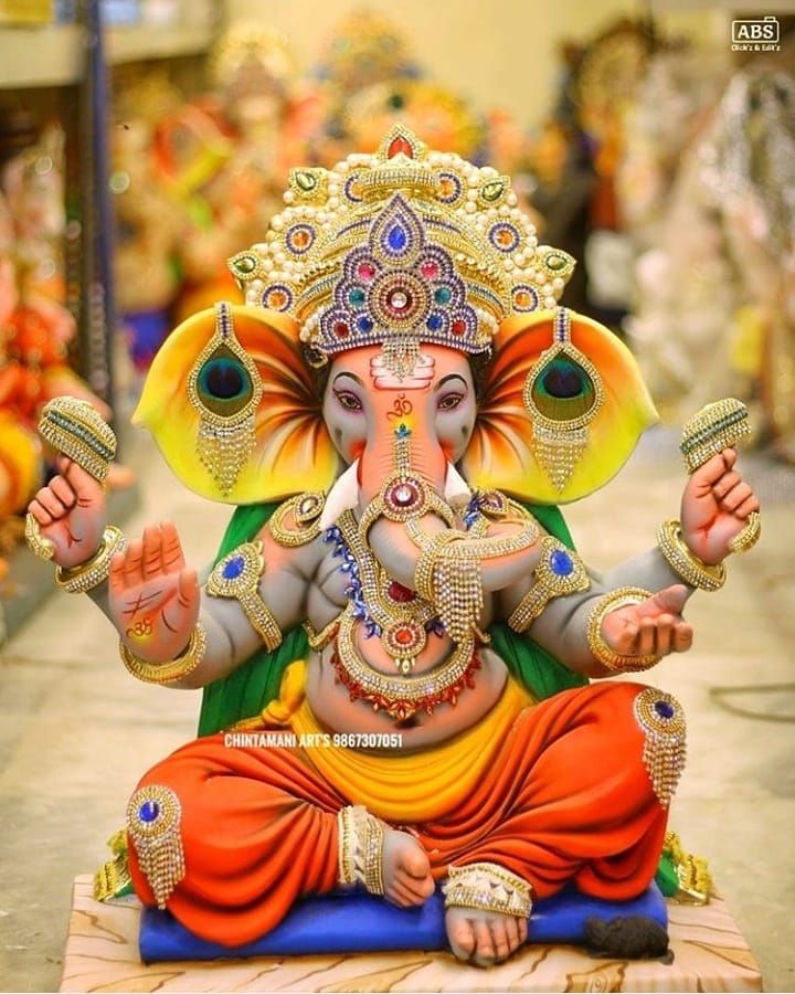 an elephant statue sitting on top of a blue mat