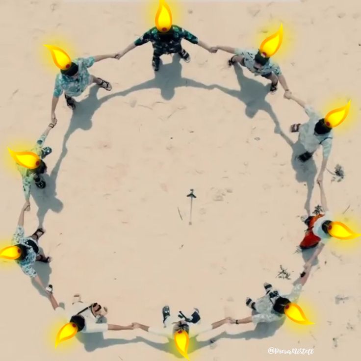 a group of people standing in the middle of a circle with yellow lights on them