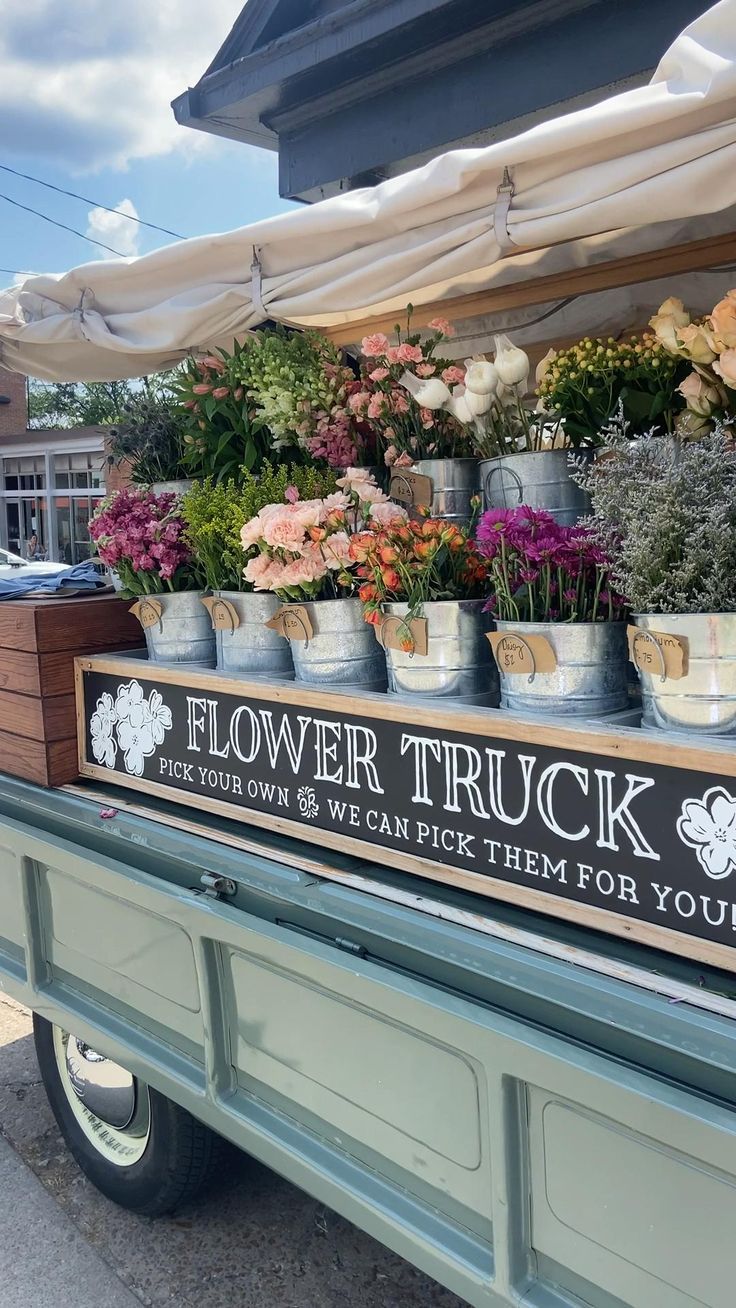 the flower truck has many potted plants in it