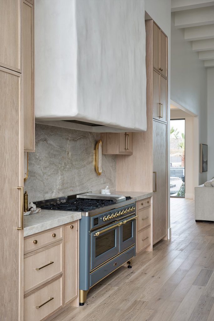 a kitchen with an oven, stove and wooden cabinets in it's center island