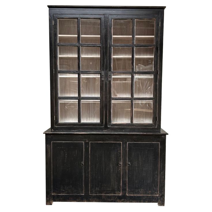 an old black china cabinet with glass doors and shelves on the front, isolated against a white background