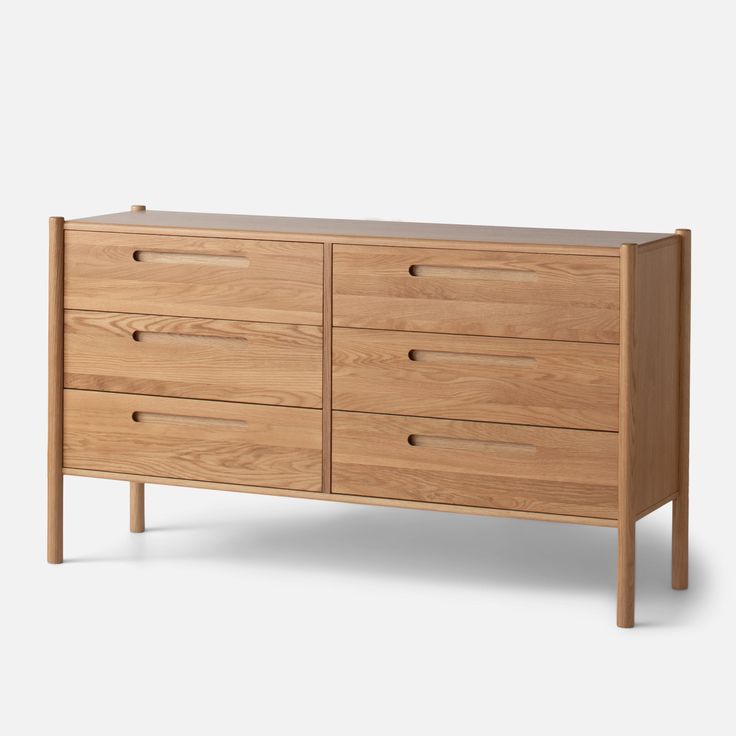 a wooden dresser with four drawers and two legs