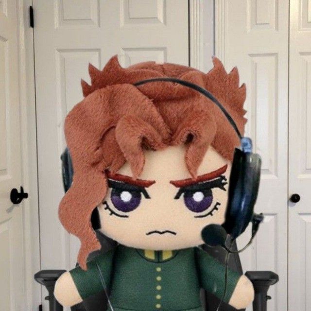 a stuffed doll with headphones on sitting in front of a door