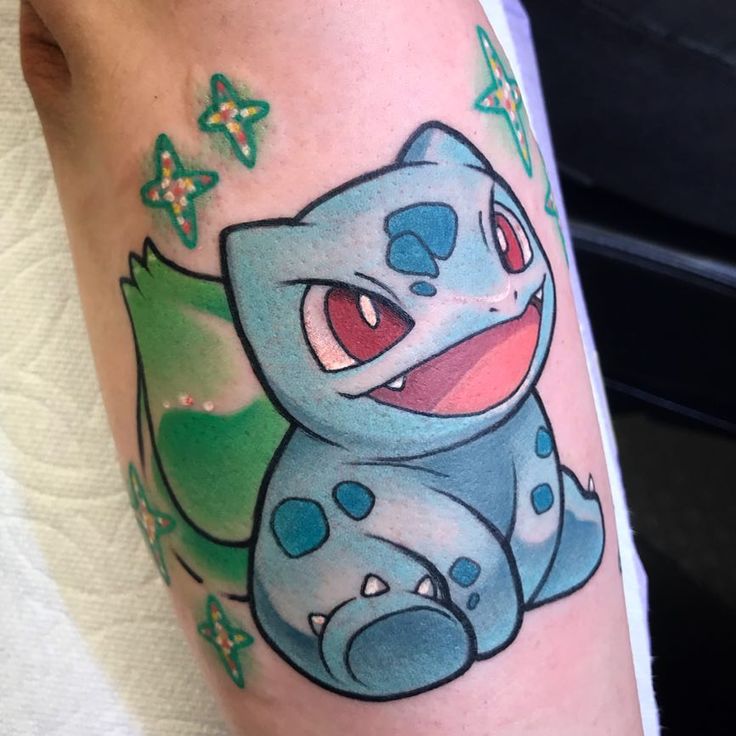 a person with a pokemon tattoo on their leg