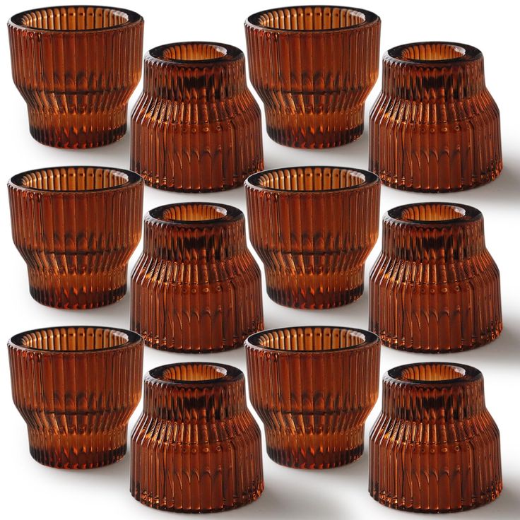 a bunch of brown glass vases sitting next to each other