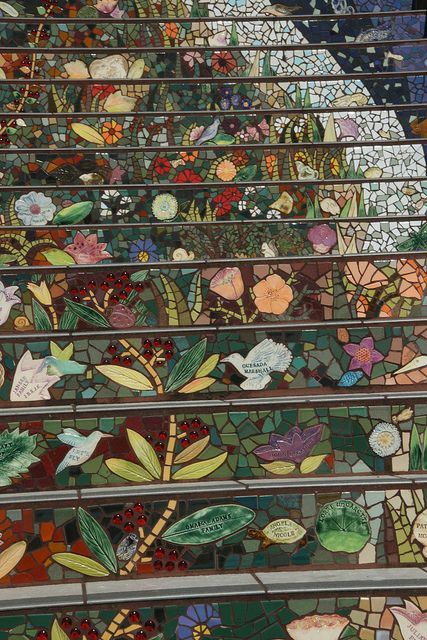 the stairs are decorated with colorful flowers and leaves