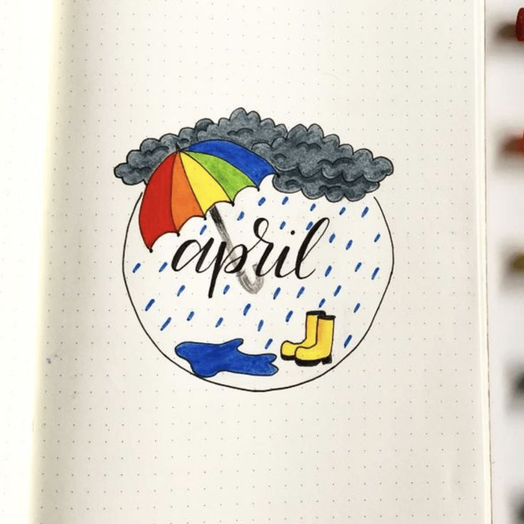 an open notebook with the words april written on it and a drawing of a rain cloud