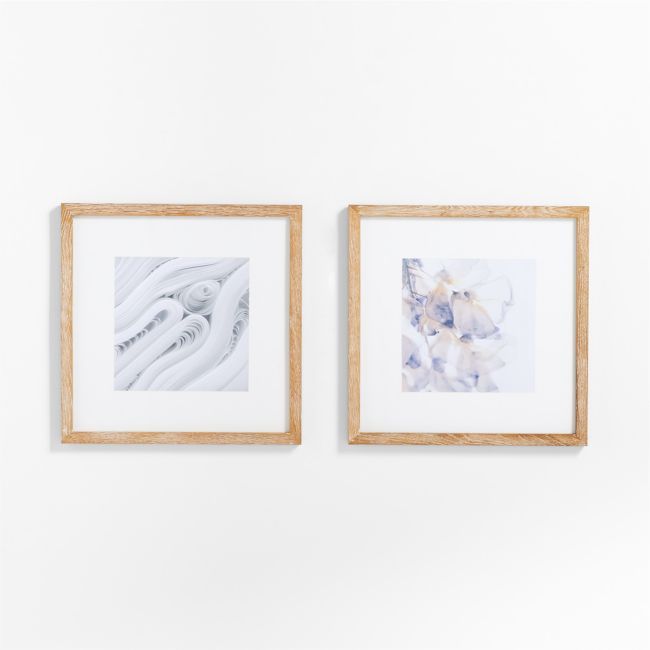 two framed photographs hang on the wall next to each other in front of a white wall