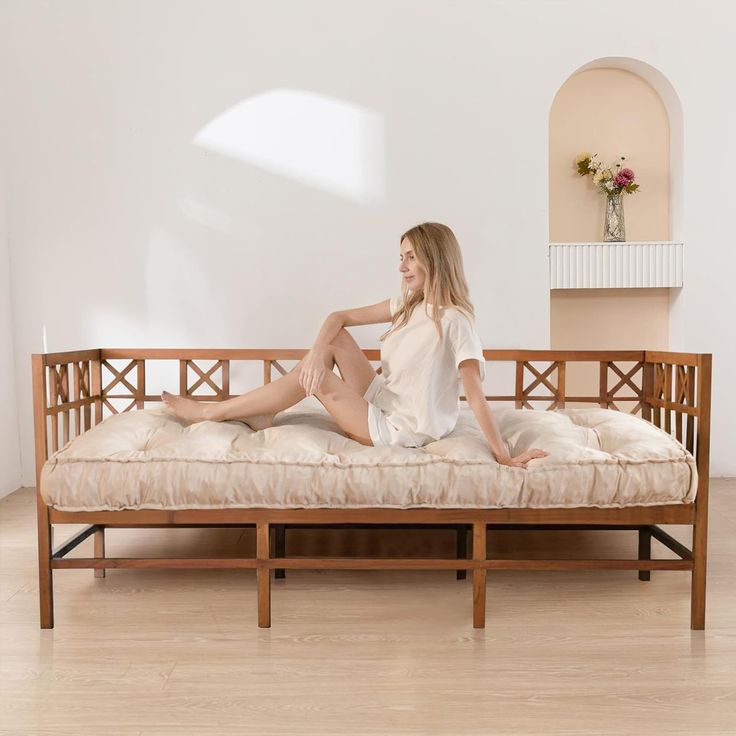 a woman sitting on top of a wooden couch