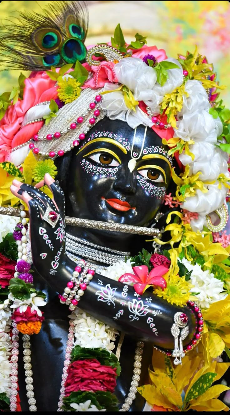 the statue is decorated with flowers and feathers