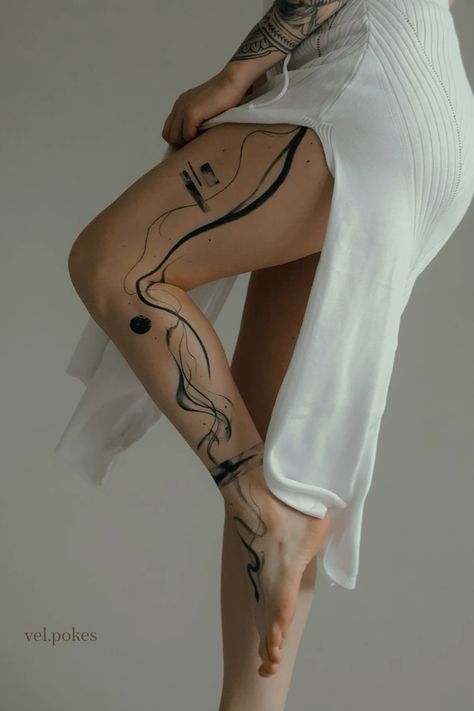 a woman with tattoos on her legs is posing