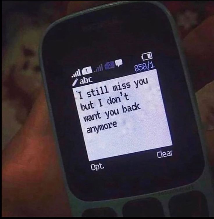 someone is texting on their cell phone with the message i still miss you but i don't want you back anymore