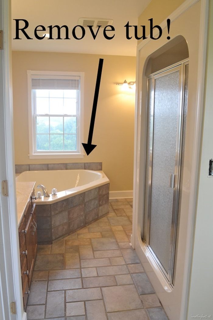 a bathroom with a walk in shower next to a bath tub