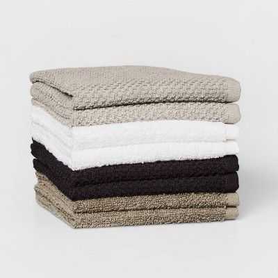 five towels stacked on top of each other in different colors and sizes, all folded together