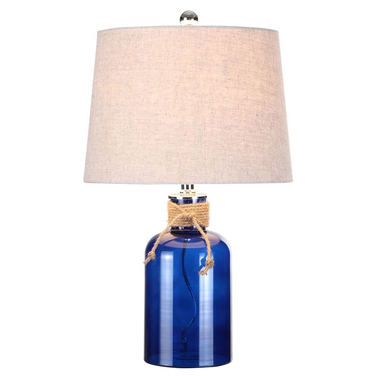 a blue glass table lamp with a white linen shade on the bottom and a rope wrapped around the base