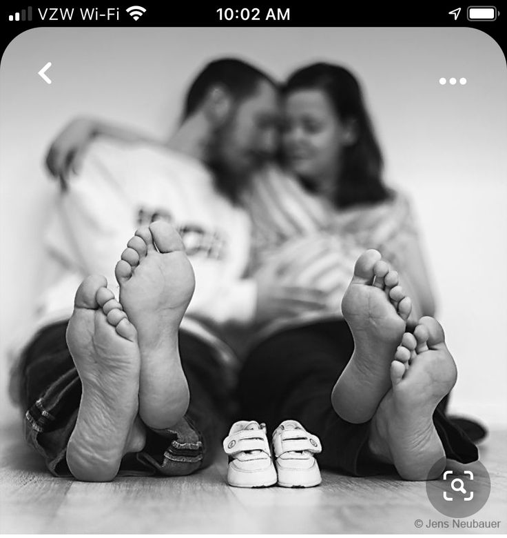 two people are laying on the floor with their feet propped up next to each other