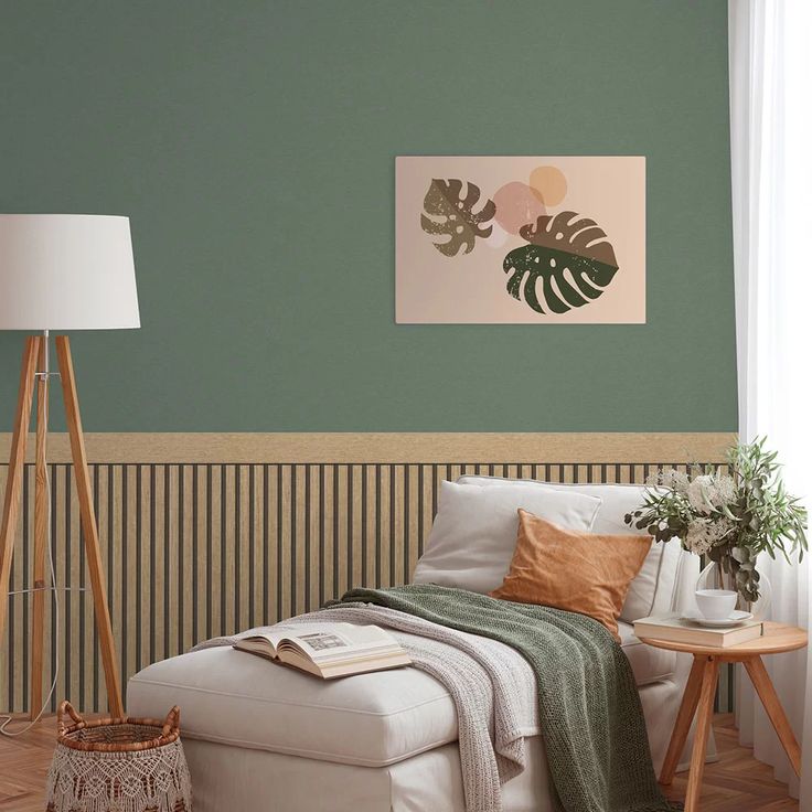 a living room with green walls and white furniture