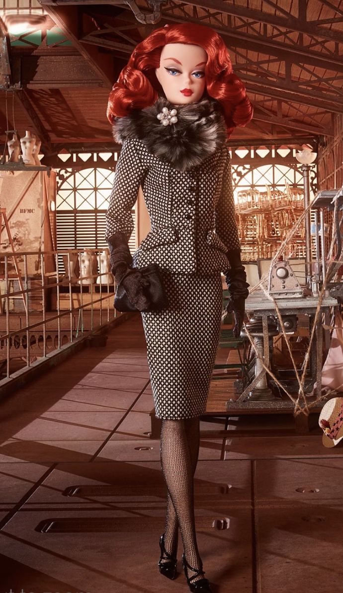 a woman in a dress and hat walking down a hall with other mannequins