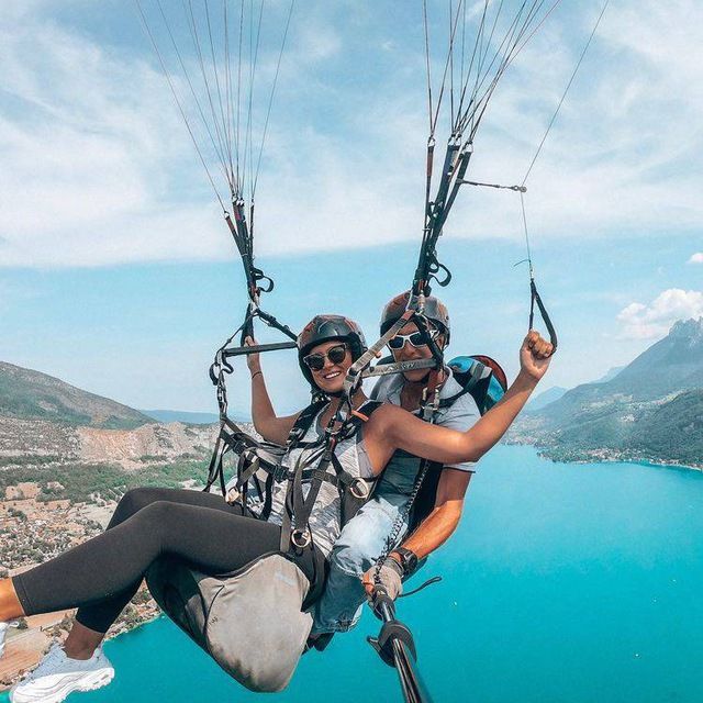 two people are parasailing over the water