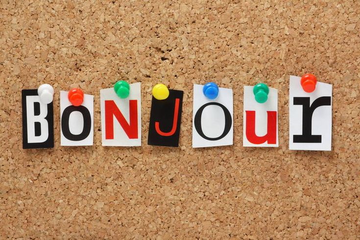 the word bonjou written in cut out letters on a cork notice board