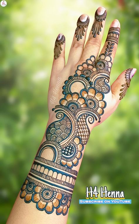 a woman's hand with henna tattoos on it