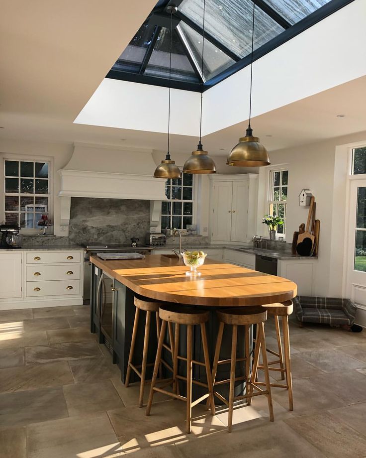 a kitchen with an island and three stools