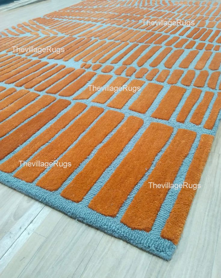 an orange and blue rug on the floor