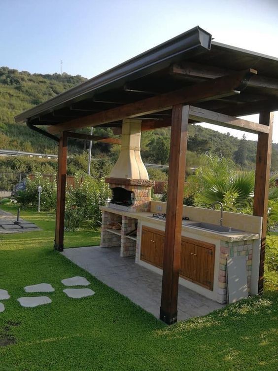 an outdoor kitchen is shown in the grass