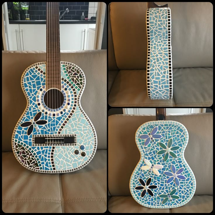 the guitar is made out of mosaic tiles and has been painted with blue flowers on it