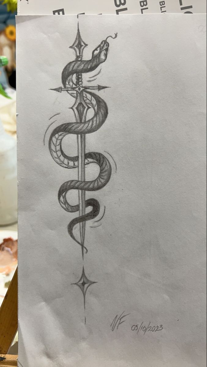 a pencil drawing of a snake and dagger on paper next to a vase with flowers