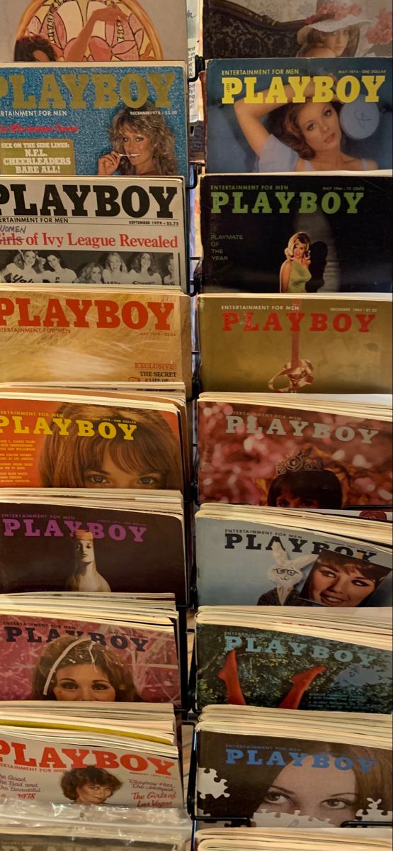 there are many magazines stacked on top of each other in this store display case for sale