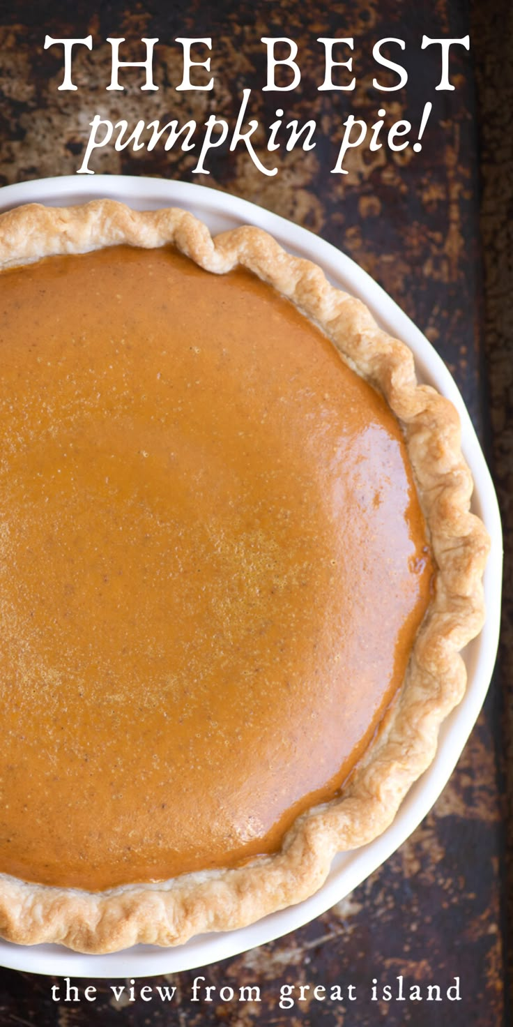 a pumpkin pie in a white bowl on a table with the words, the best pumpkin pie