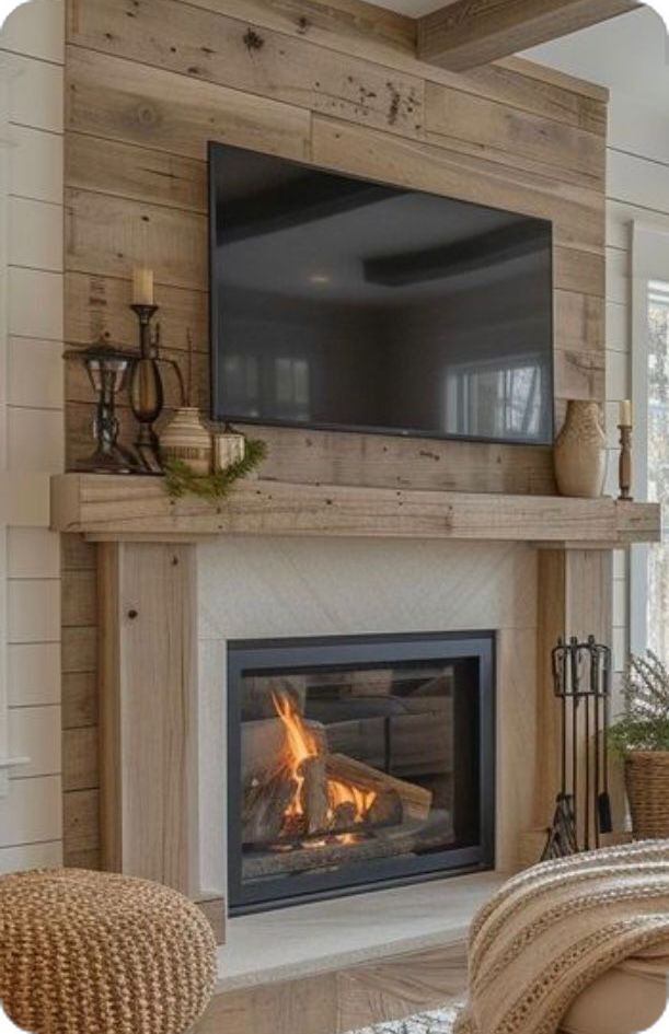 a living room with a fire place and television mounted on the wall above it's fireplace