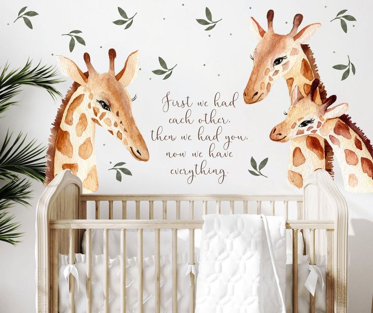 two giraffes are standing next to each other near a baby crib