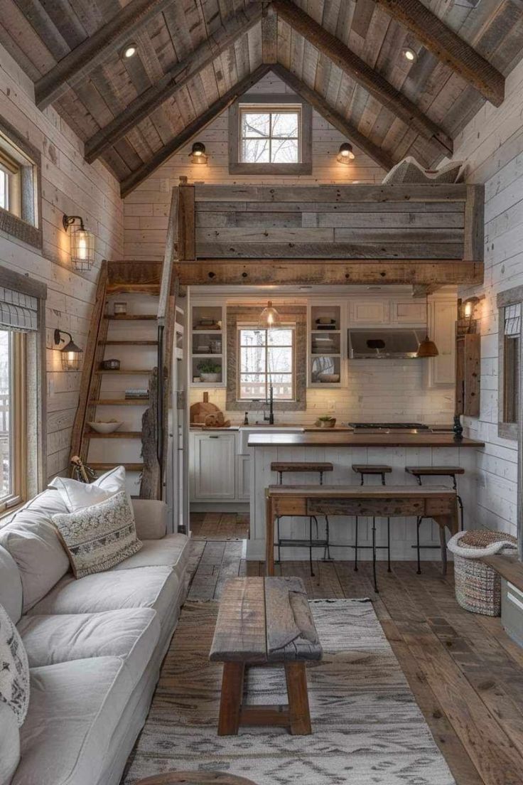 a living room filled with furniture next to a kitchen and dining area in a house