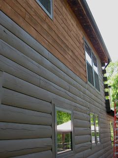 the side of a house that is being constructed with siding and wood shinnings