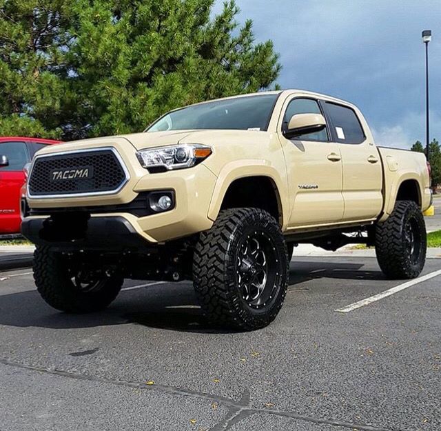 a tan toyota truck parked in a parking lot