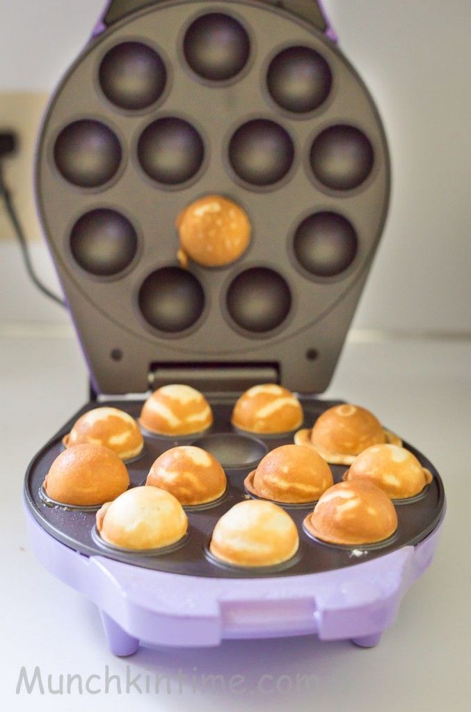 a waffle maker filled with muffins on top of a table