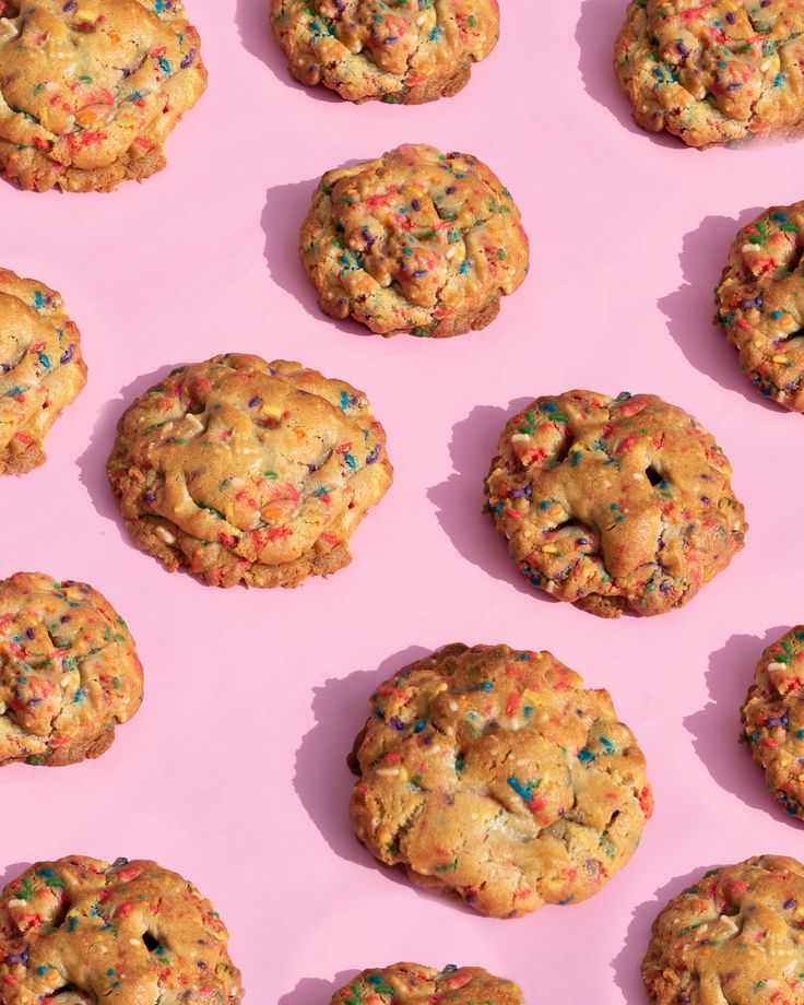 chocolate chip cookies with sprinkles on a pink background