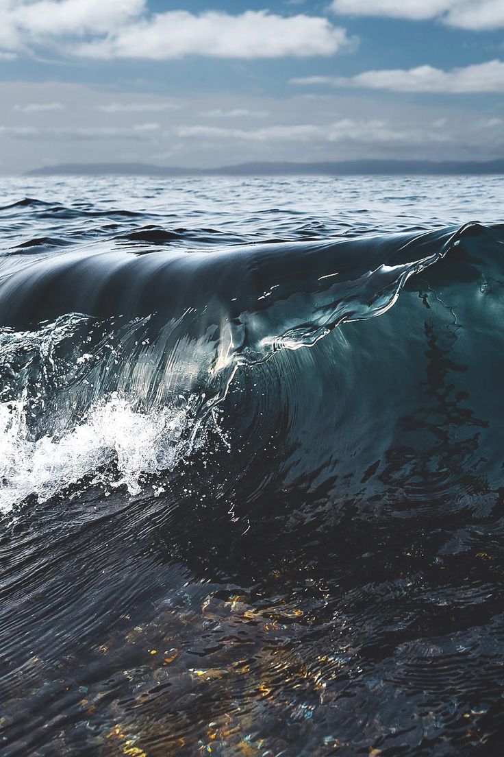 an ocean wave is breaking on the water