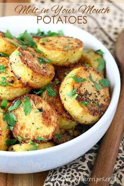 a white bowl filled with potatoes on top of a table