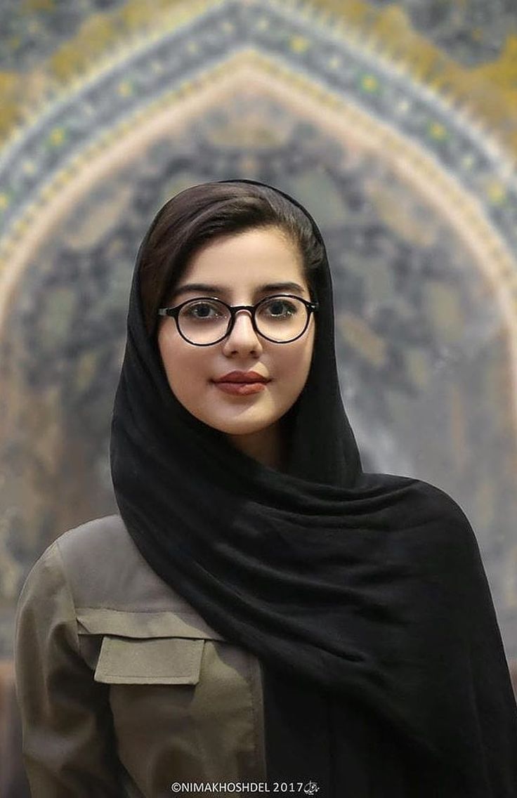 a woman wearing glasses and a hijab