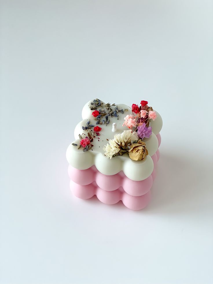 a pink and white object with flowers on it