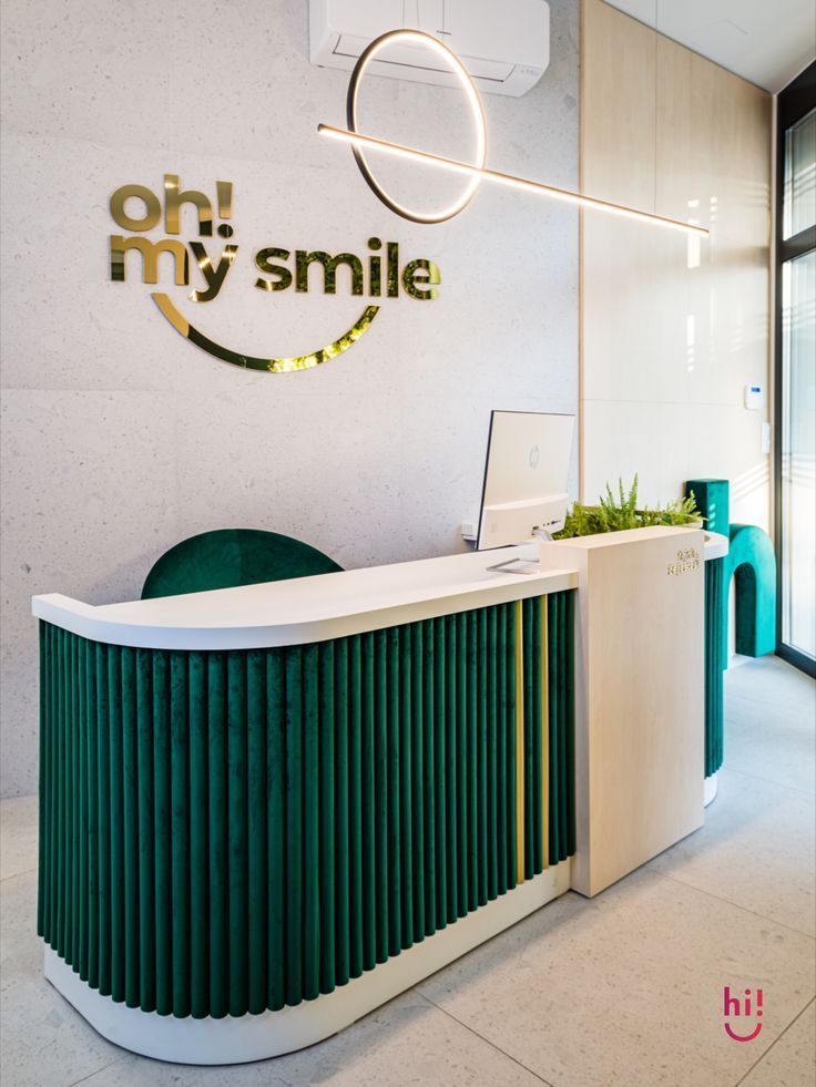 an office with a green and white reception desk